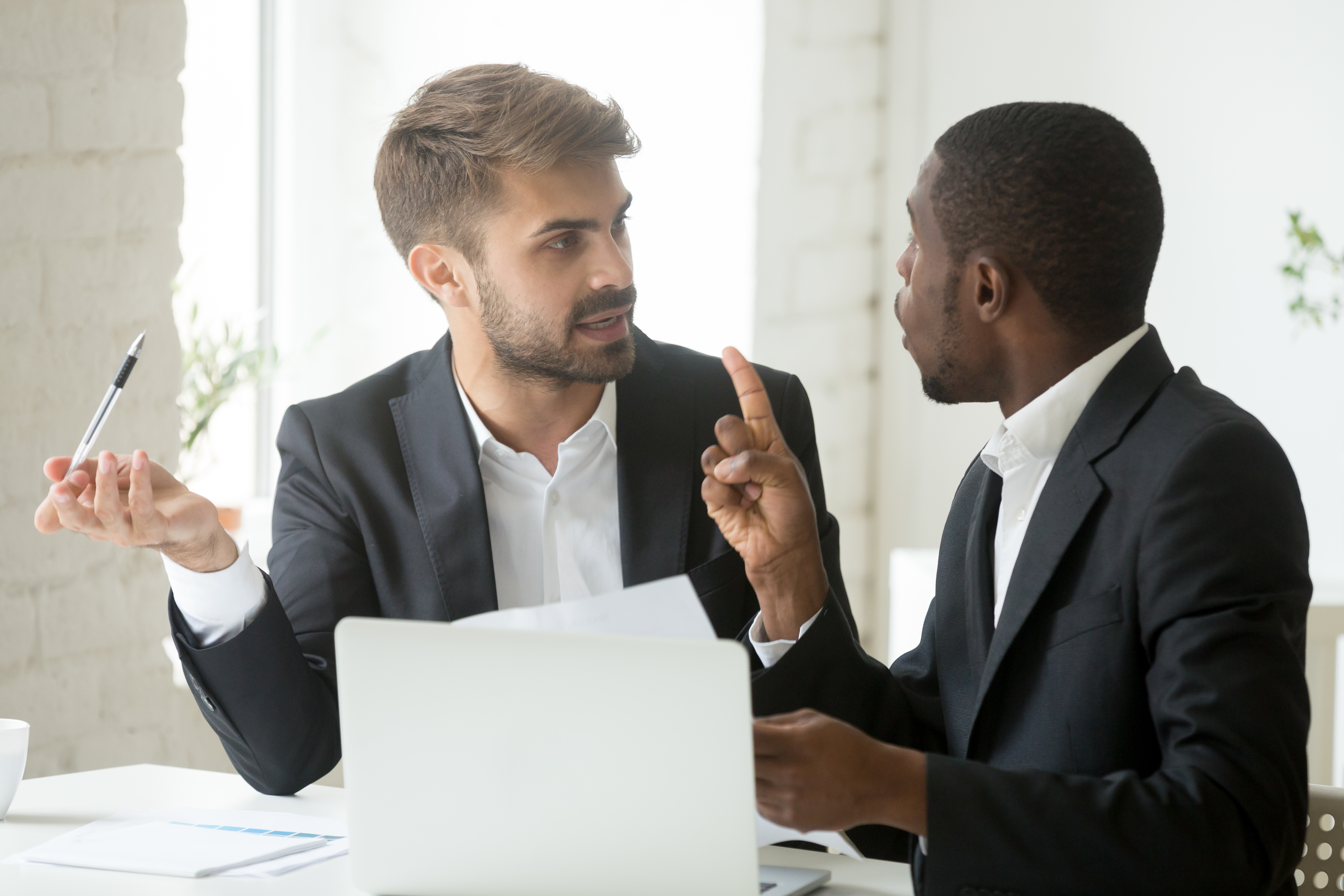 Two men arguing over legal papers